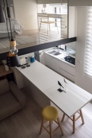 A vanity table placed at the corner of the sleeping area allows the light to flow in for makeup application at its best.