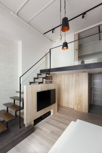 The color palette of light woods, white walls, and black fixtures carries through on both levels.