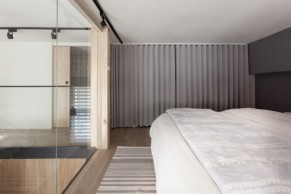 A simple curtain pulls over the closet, creating texture as a floor to ceiling “wall” while eliminating visual clutter.