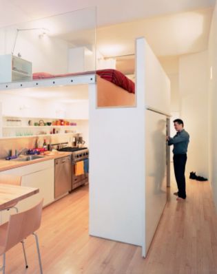 Located in New York City’s Union Square area, this 700-square-foot apartment features a bedroom lofted above a full kitchen. The volume that both incorporates the single closet (accessible from the hallway) and the refrigerator (which opens into the kitchen) and serves as the bedroom floor is, says resident Kyu Sung Woo, “where everything comes together.” Photo by Adam Friedberg
