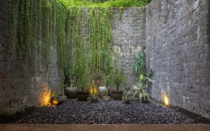 The importance of the outdoor space is further emphasized by the small nooks and crannies that are part of the architecture, like this cozy garden.